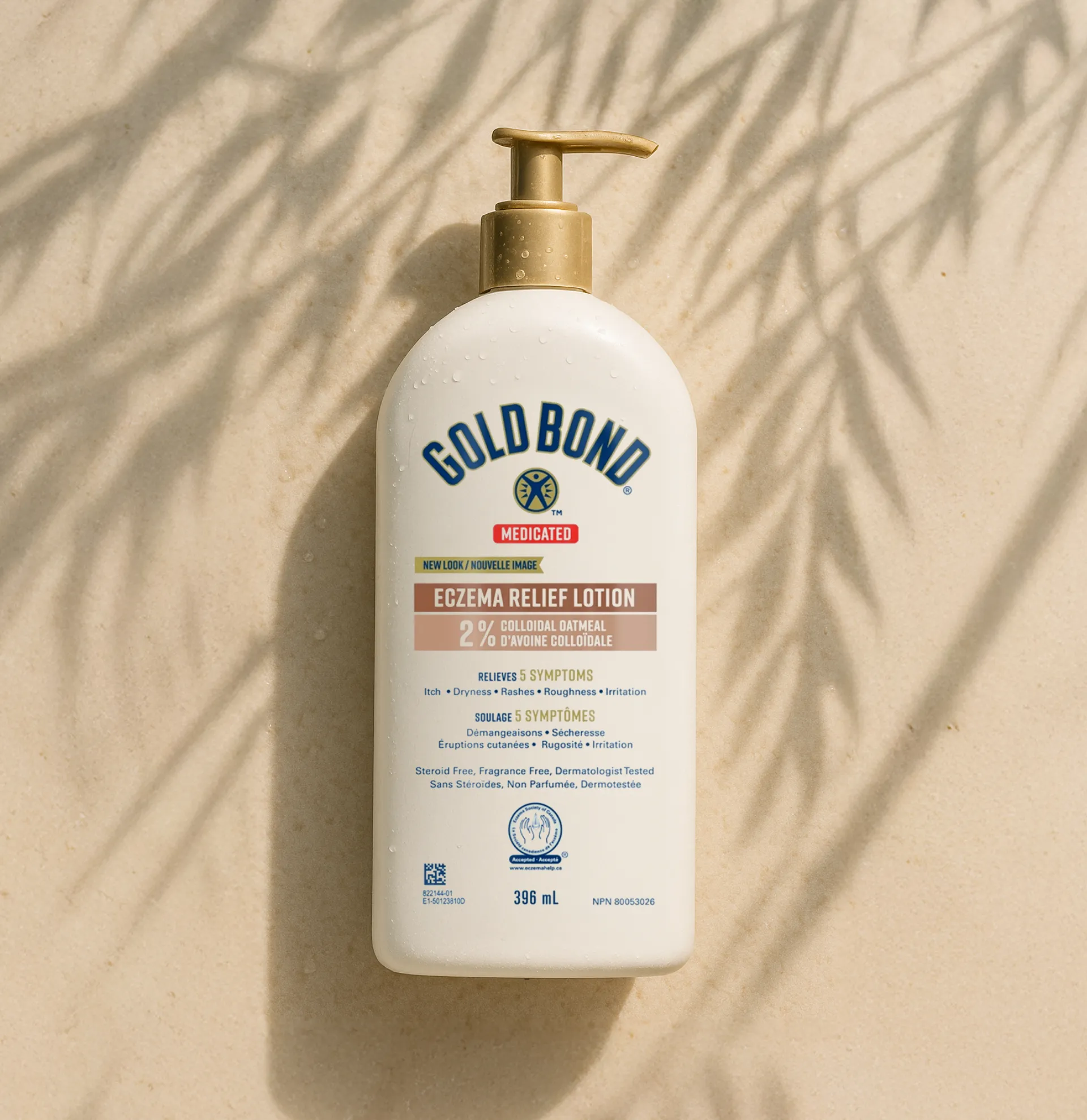 A hand squeezing Gold Bond Age Renew Crepe Corrector Body Lotion, with visible white cream on the other hand.