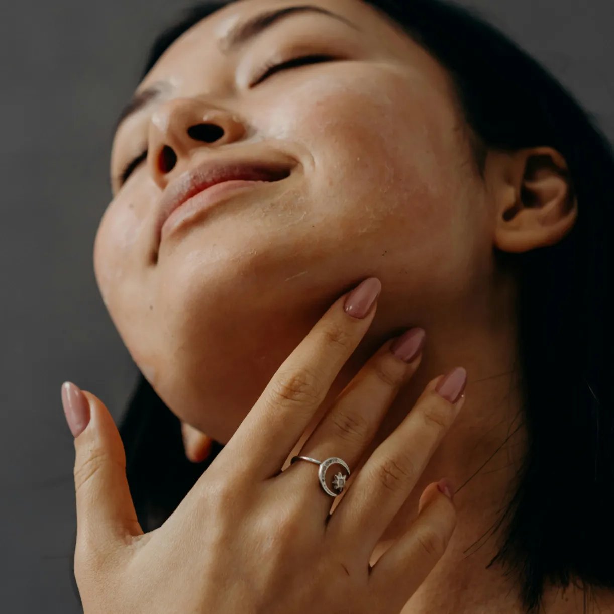 Close-up of a woman's arm as she applies a bit of cream.