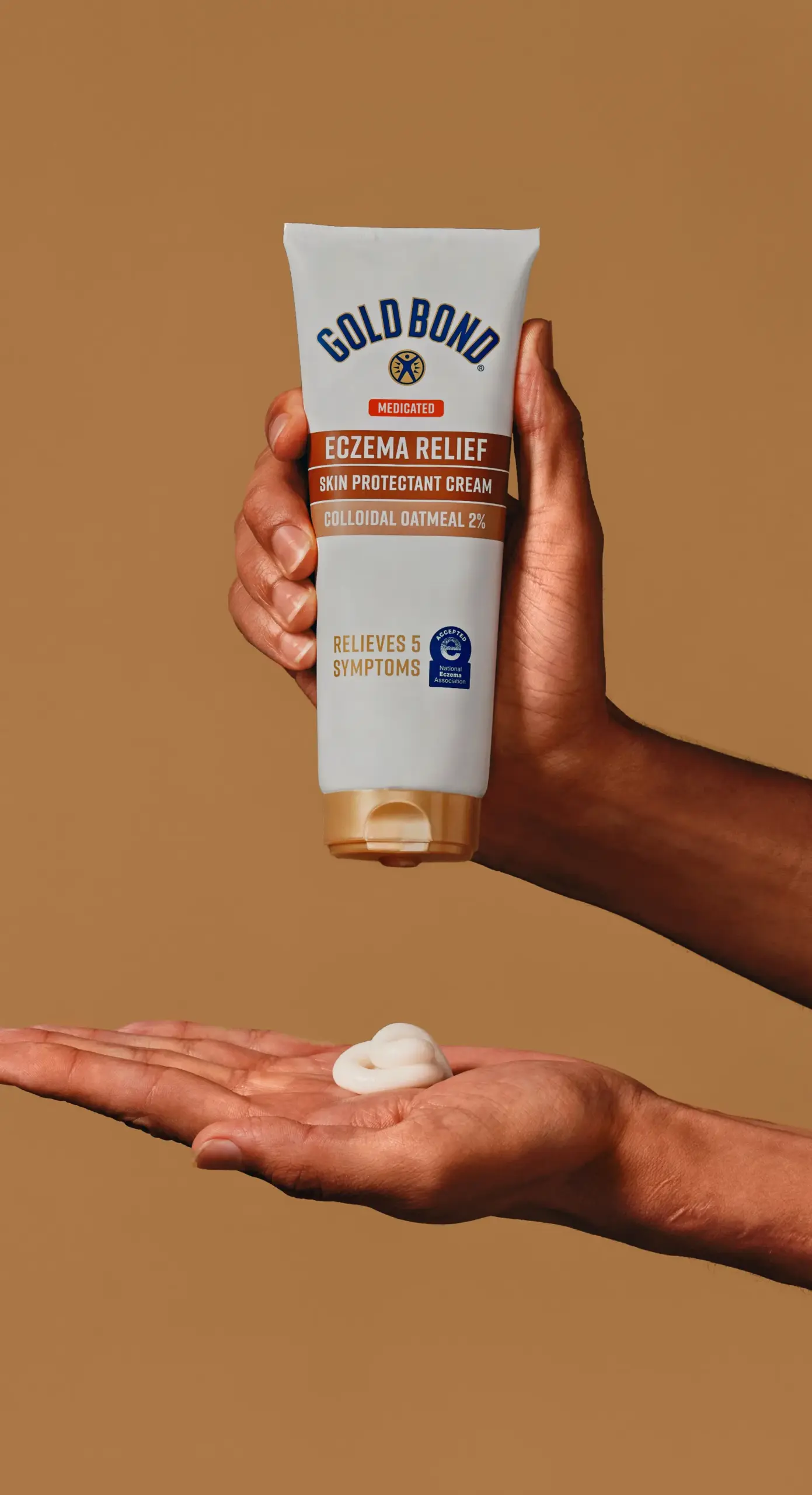 Man squeezing eczema relief lotion on his hand.
