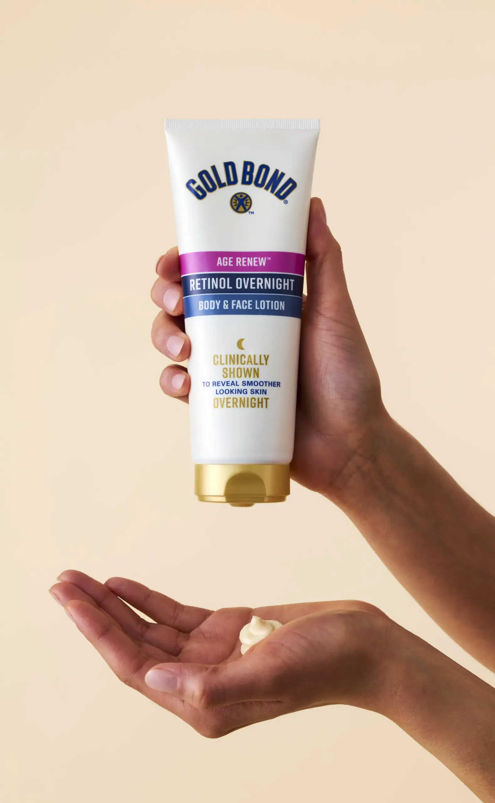 Hands holding Goldbond Overnight Retinol cream.
